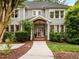 Beautiful two-story home featuring a covered front porch, gray siding, lush landscaping, and a welcoming entrance at 105 Jolyn Pl, Chapel Hill, NC 27517