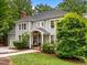 Charming gray two-story home with a welcoming front porch and manicured landscaping surrounded by mature trees at 105 Jolyn Pl, Chapel Hill, NC 27517