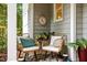 Cozy front porch featuring wicker chairs with comfy cushions, a stylish rug, and decorative accents at 105 Jolyn Pl, Chapel Hill, NC 27517