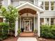 A close up view of the covered front porch, brick platform, and tasteful decorations at 105 Jolyn Pl, Chapel Hill, NC 27517