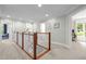 Bright hallway with carpet and white railing leading to bedrooms and a view of the office at 105 Jolyn Pl, Chapel Hill, NC 27517