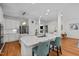 Open-concept kitchen with a large island, white cabinets, stainless steel appliances, and hardwood floors at 105 Jolyn Pl, Chapel Hill, NC 27517