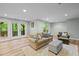 Inviting living area with light-colored sofa and plush ottoman near the sliding glass doors at 105 Jolyn Pl, Chapel Hill, NC 27517