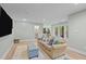 Spacious living area with wood flooring, comfortable seating, and access to outdoor spaces at 105 Jolyn Pl, Chapel Hill, NC 27517