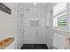 Shower with subway tile and black river stone, glass door, rain shower head at 105 Jolyn Pl, Chapel Hill, NC 27517