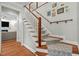 Elegant staircase with wooden treads, white risers, and a patterned runner leading to the upper level at 105 Jolyn Pl, Chapel Hill, NC 27517