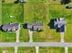 Aerial view of a home with a spacious yard, surrounded by other residences, showcasing the neighborhood layout at 108 Hudson Dr, Princeton, NC 27569