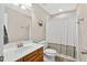 Neutral bathroom featuring a wooden vanity, sink, toilet, and shower-tub combo at 108 Hudson Dr, Princeton, NC 27569