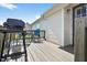 Spacious outdoor deck featuring a grill, seating area and a side entrance at 108 Hudson Dr, Princeton, NC 27569