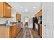 Well-lit kitchen showcasing wooden cabinets, stainless steel appliances, and hardwood flooring at 108 Hudson Dr, Princeton, NC 27569