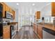 Spacious kitchen featuring stainless steel appliances, wooden cabinets, and hardwood flooring at 108 Hudson Dr, Princeton, NC 27569
