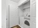 Bright laundry room with a white washer and dryer, and white walls at 108 Hudson Dr, Princeton, NC 27569