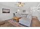 Comfortable living room with plush seating, ceiling fan, and hardwood floors at 108 Hudson Dr, Princeton, NC 27569