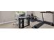 Bright office with various desks, workout equipment, and light carpet at 108 Hudson Dr, Princeton, NC 27569