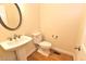 Powder room with pedestal sink, wood flooring, and neutral paint at 1126 Falling River Walk, Rocky Mount, NC 27804