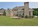 Back exterior of two story brick home with manicured lawn at 1126 Falling River Walk, Rocky Mount, NC 27804