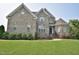 Charming two-story brick home featuring well-manicured landscaping and a welcoming entrance at 1126 Falling River Walk, Rocky Mount, NC 27804