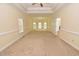 Open living room featuring large windows, ceiling fan, and access to other rooms at 1126 Falling River Walk, Rocky Mount, NC 27804