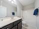 Bathroom with a single sink vanity with dark cabinets, white countertop, toilet and shower-tub combo at 115 Snowy Orchid Ln, Smithfield, NC 27577