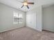 Bedroom with a ceiling fan, carpet, window, and closet doors creating a cozy and functional space at 115 Snowy Orchid Ln, Smithfield, NC 27577