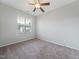 Bedroom with neutral walls, carpet, and natural light from the window, complemented by a ceiling fan at 115 Snowy Orchid Ln, Smithfield, NC 27577