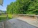The back deck offers an outdoor space for relaxing and enjoying the green lawn and trees at 115 Snowy Orchid Ln, Smithfield, NC 27577