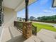 View from the front porch with stone and wood details at 115 Snowy Orchid Ln, Smithfield, NC 27577