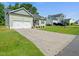 Well-maintained home with a long driveway and lush front lawn at 115 Snowy Orchid Ln, Smithfield, NC 27577