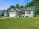 Charming home with a well-manicured lawn and an attached two-car garage at 115 Snowy Orchid Ln, Smithfield, NC 27577