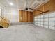 Spacious two-car garage featuring concrete flooring and unfinished drywall at 115 Snowy Orchid Ln, Smithfield, NC 27577