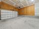 Spacious two-car garage featuring concrete flooring and unfinished drywall at 115 Snowy Orchid Ln, Smithfield, NC 27577