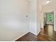 Hallway with wood floors and light grey walls at 115 Snowy Orchid Ln, Smithfield, NC 27577