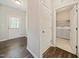 Entryway featuring wood floors, neutral paint, and a laundry room at 115 Snowy Orchid Ln, Smithfield, NC 27577