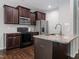Kitchen featuring stainless steel appliances, granite countertops, and dark cabinets at 115 Snowy Orchid Ln, Smithfield, NC 27577