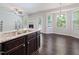 Spacious open floorplan, featuring stainless steel faucet and view of dining area and fireplace at 115 Snowy Orchid Ln, Smithfield, NC 27577