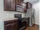 Kitchen featuring stainless steel appliances, granite countertops, and dark cabinets at 115 Snowy Orchid Ln, Smithfield, NC 27577