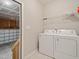 Laundry room with washer, dryer, and an open door leading to the garage at 115 Snowy Orchid Ln, Smithfield, NC 27577