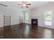 Comfortable living room with a fireplace and dark wood-look floors, and bright natural light at 115 Snowy Orchid Ln, Smithfield, NC 27577
