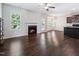 Open concept living area with fireplace, windows, and access to the backyard at 115 Snowy Orchid Ln, Smithfield, NC 27577