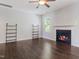 Open living room features dark wood-look floors, fireplace, and shelving at 115 Snowy Orchid Ln, Smithfield, NC 27577