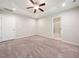 Spacious main bedroom featuring a ceiling fan and ensuite bathroom entrance at 115 Snowy Orchid Ln, Smithfield, NC 27577