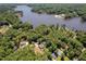 Beautiful aerial view of homes nestled among lush trees near a serene lake, offering a peaceful and picturesque setting at 1176 Sagamore Dr, Louisburg, NC 27549