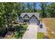 Aerial view of a two-story home with a long driveway and a well-landscaped front yard at 1176 Sagamore Dr, Louisburg, NC 27549