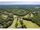 Scenic aerial view of a golf course and neighborhood nestled within a lush forest landscape at 1176 Sagamore Dr, Louisburg, NC 27549