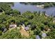 Aerial shot of the property near the lake with a sprawling backyard and lush greenery, a serene setting at 1176 Sagamore Dr, Louisburg, NC 27549