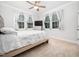 Comfortable bedroom with large windows, neutral walls, and ceiling fan at 1176 Sagamore Dr, Louisburg, NC 27549