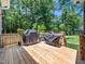 Outdoor deck with a gas grill and cooking station, perfect for backyard cookouts and entertaining guests at 1176 Sagamore Dr, Louisburg, NC 27549