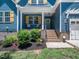 Inviting front porch with decorative plants, cozy seating, and charming details enhancing the home's curb appeal at 1176 Sagamore Dr, Louisburg, NC 27549