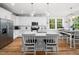 Bright kitchen with white cabinets, stainless steel appliances, quartz countertops and a dining area at 1176 Sagamore Dr, Louisburg, NC 27549