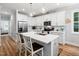 Spacious kitchen features white cabinets, stainless appliances, quartz counters, and a stylish island at 1176 Sagamore Dr, Louisburg, NC 27549